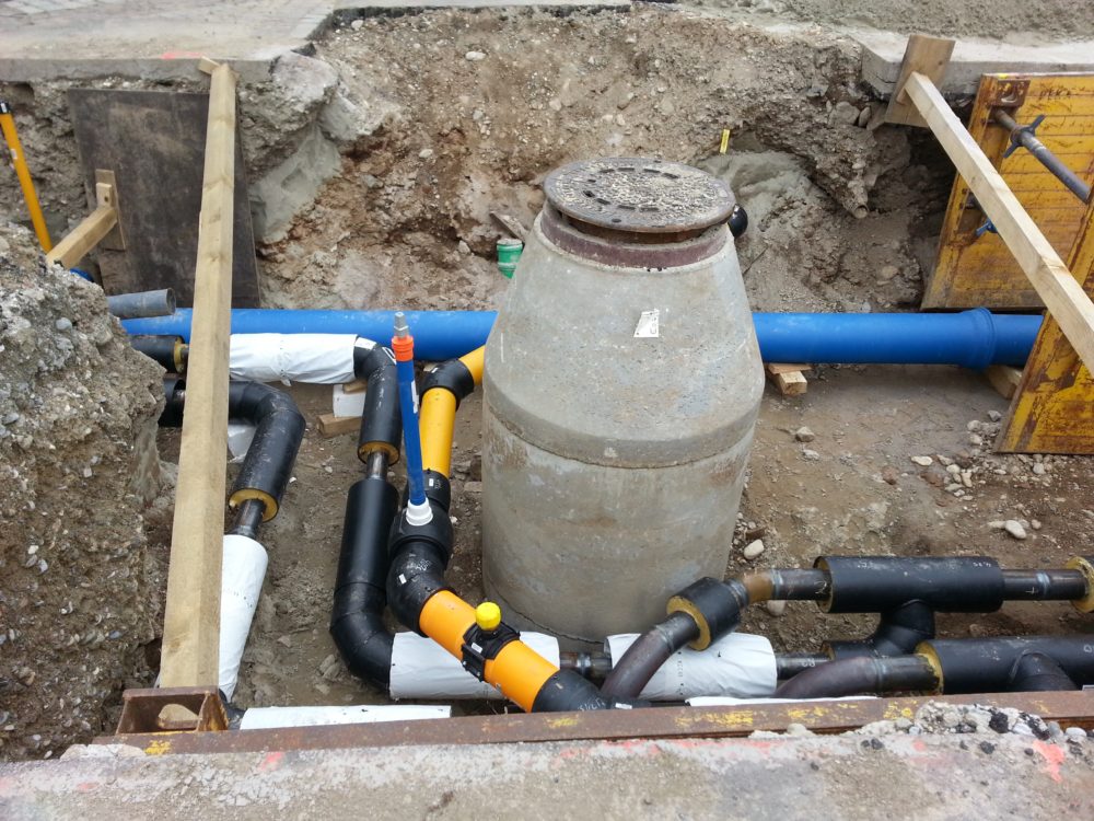 Buried utilities around a manhole vault